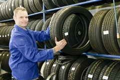 Man holding up tire